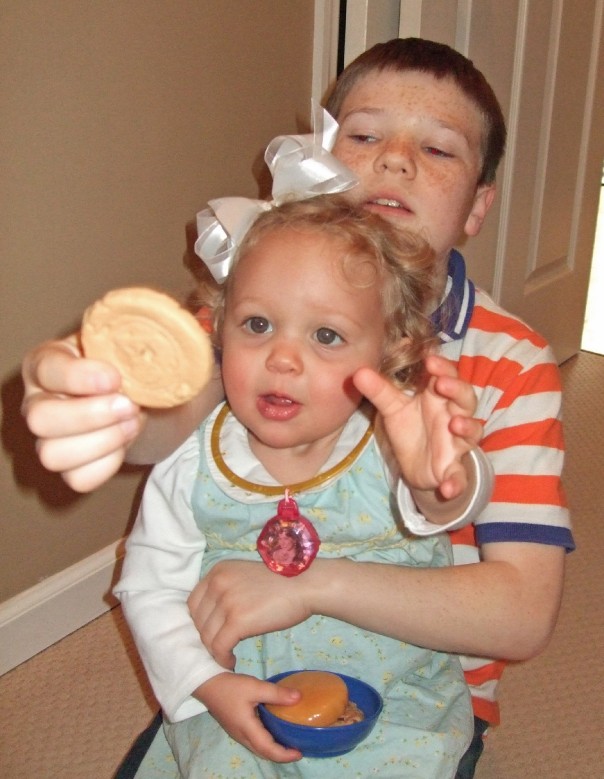 Cousin Jake and EK playing with fake food (I think it's fake)
