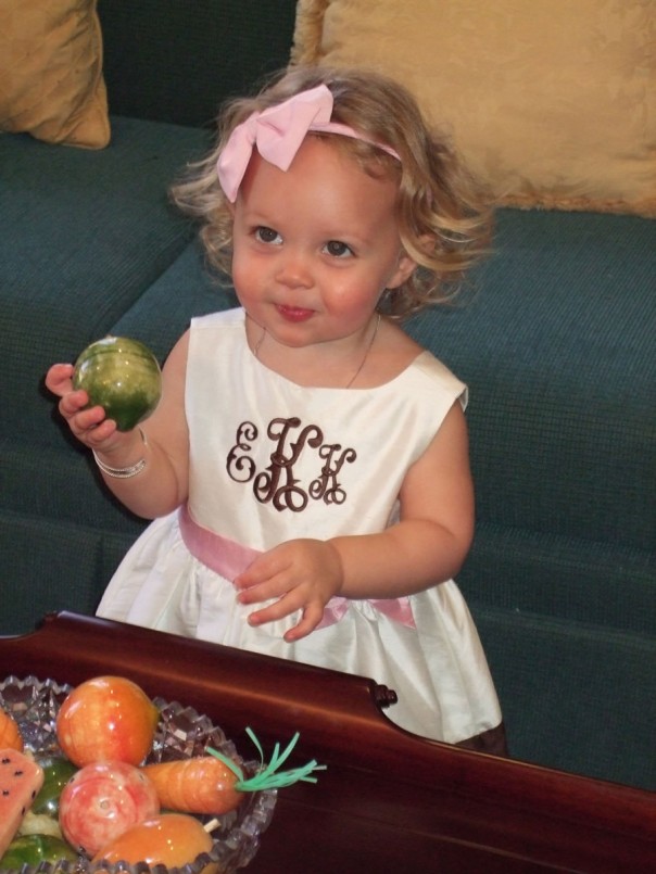pretending to eat glass fruit in the church's Welcome Center