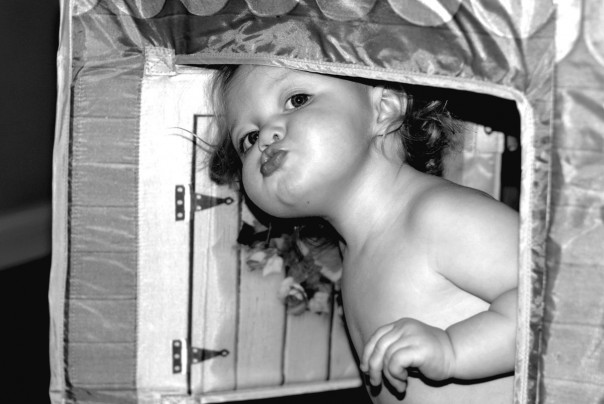 Coming out of her playhouse giving kisses to mommy and daddy