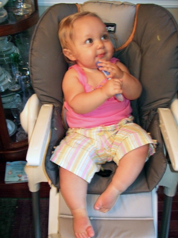 "Miss Independent" insisted on feeding herself. It's hard to see in this photo, but her entire outfit was covered with food. Tobi enjoyed cleaning up afterwards. :-)